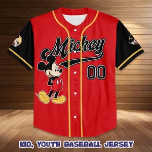 May include: Red baseball jersey featuring Mickey Mouse with the word "Mickey" in black script. The jersey has black sleeves with yellow trim, the number "00", and the text "KID, YOUTH BASEBALL JERSEY".