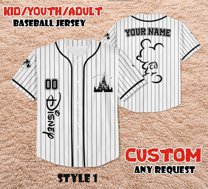 May include: White baseball jersey with black pinstripes, featuring the word "Disney" in script, the number "00", and a castle silhouette. The back of the jersey has the text "YOUR NAME" and a Mickey Mouse outline. The jersey is labeled "KID/YOUTH/ADULT BASEBALL JERSEY".