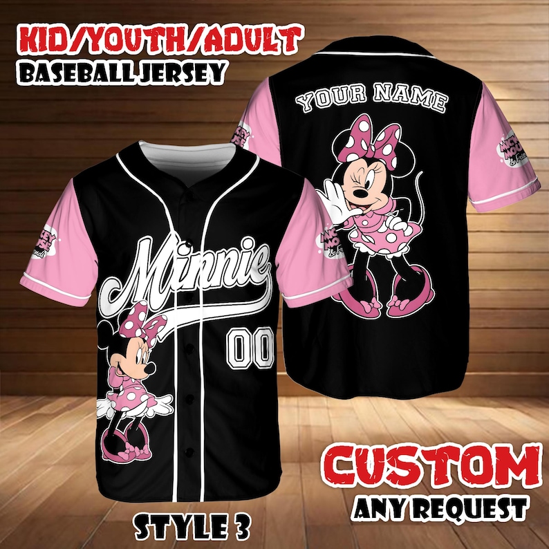 May include: Black baseball jersey with pink sleeves featuring a Minnie Mouse design. The jersey has the word "Minnie" in white script, the number "00", and the text "KID/YOUTH/ADULT BASEBALL JERSEY". The back of the jersey has the text "YOUR NAME" and a Minnie Mouse graphic.