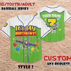 May include: A green and white baseball jersey with the text "It's My Birthday!" and a Buzz Lightyear graphic. The jersey has purple accents and the text "YOUR NAME" on the back. The jersey is for kids, youth, or adults.