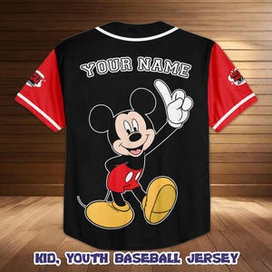 May include: Black baseball jersey with red sleeves and white trim. Features a large Mickey Mouse graphic on the back with the text "YOUR NAME" above the character. The bottom of the jersey reads "KID, YOUTH BASEBALL JERSEY".