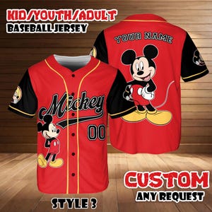 May include: Red baseball jersey with black sleeves and yellow trim. Features the word "Mickey" and the number "00" on the front, and a Mickey Mouse graphic. The back has a Mickey Mouse graphic and the words "YOUR NAME".