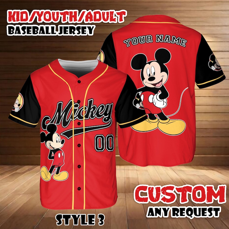 May include: Red baseball jersey with black sleeves and yellow trim. Features the word "Mickey" and the number "00" on the front, and a Mickey Mouse graphic. The back has a Mickey Mouse graphic and the words "YOUR NAME".