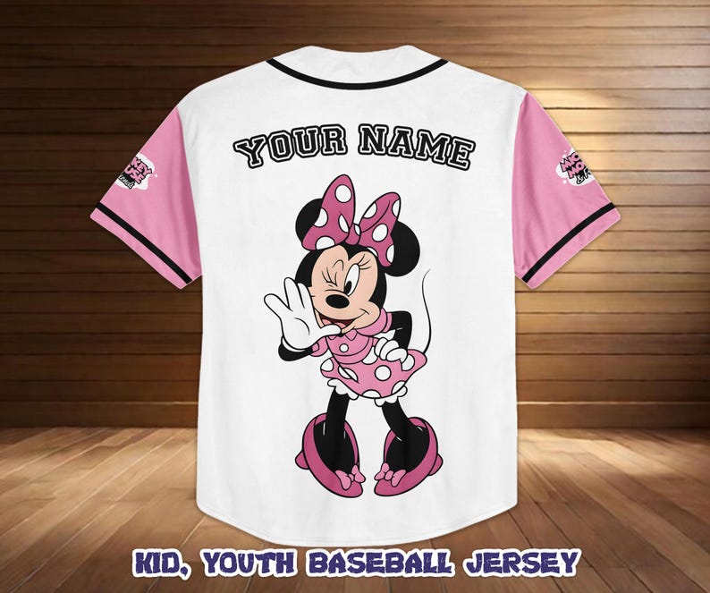 May include: White baseball jersey with pink sleeves and black trim. Features a Minnie Mouse graphic on the back, with the text "YOUR NAME" above the graphic. The text "KID, YOUTH BASEBALL JERSEY" is at the bottom.