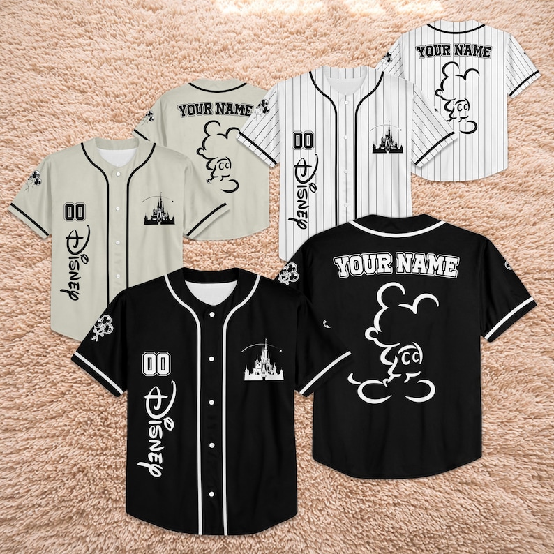 May include: Baseball jerseys in black, white, and beige with Disney-themed designs. The jerseys feature Mickey Mouse graphics, the word "Disney", the number "00", and the text "YOUR NAME".