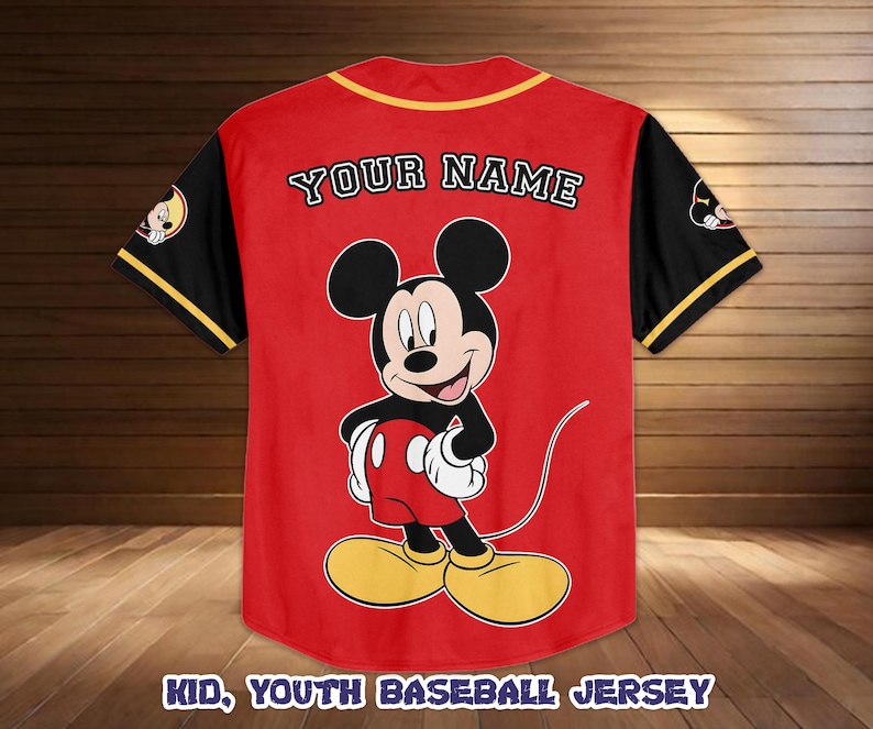 May include: Red baseball jersey with black sleeves and yellow trim. Features a large Mickey Mouse graphic on the front and the text "YOUR NAME" on the back. The bottom of the jersey reads "KID, YOUTH BASEBALL JERSEY".