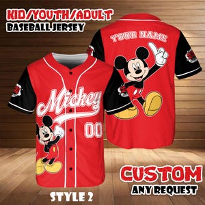 May include: Red baseball jersey with black sleeves featuring Mickey Mouse graphics. The jersey includes the text "Mickey" and the number "00". The back of the jersey has a Mickey Mouse graphic and the text "YOUR NAME". The jersey is labeled "STYLE 2" and "CUSTOM ANY REQUEST".