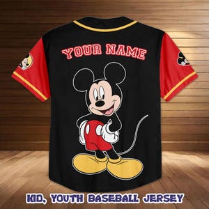 May include: Black baseball jersey with red sleeves and yellow trim. Features a large Mickey Mouse graphic on the front and the text "YOUR NAME" in red. The jersey also has the text "KID, YOUTH BASEBALL JERSEY" at the bottom.