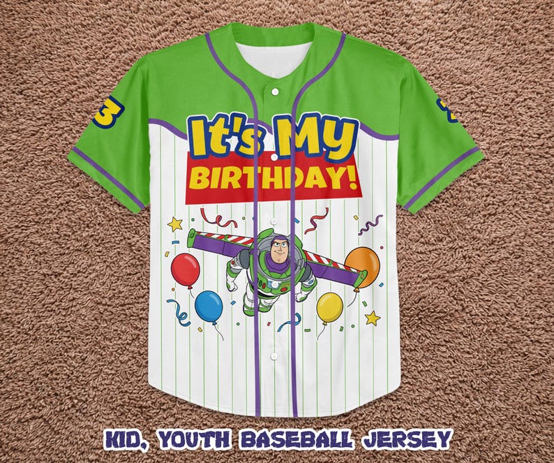 May include: Green and white baseball jersey with the text "It's My Birthday!" and a graphic of Buzz Lightyear. The jersey has purple accents and the number 3 on the sleeve. Balloons and confetti are also featured.