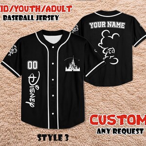 May include: Black baseball jersey with white accents, featuring the Disney logo and a castle graphic. The jersey has the text "YOUR NAME" on the back and "00" on the front. The text "KID/YOUTH/ADULT BASEBALL JERSEY" is at the top.