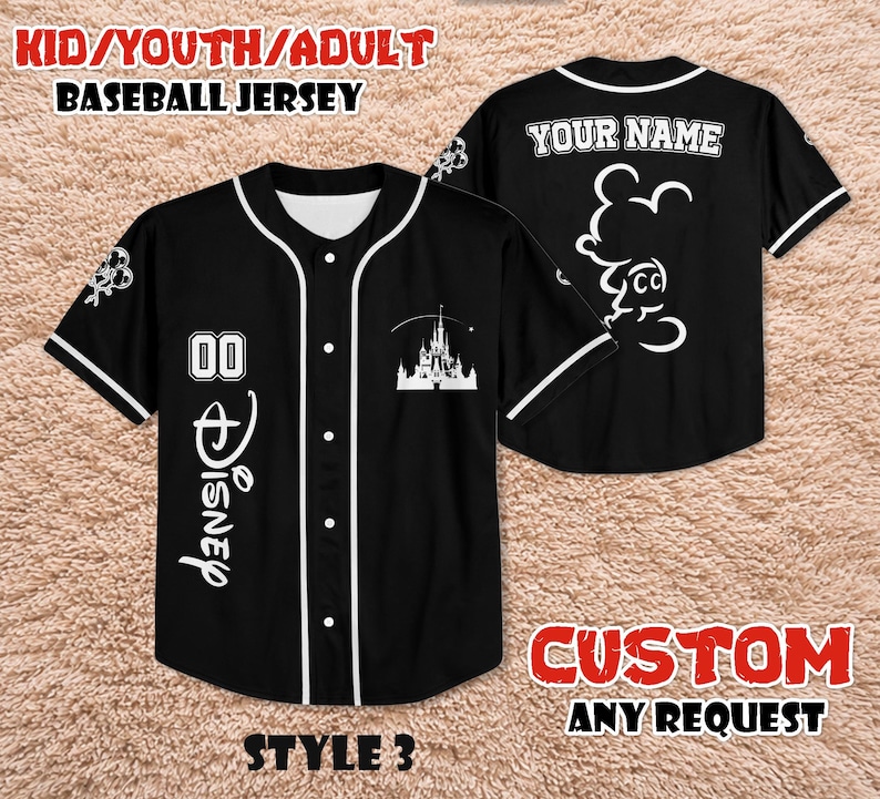 May include: Black baseball jersey with white accents, featuring the Disney logo and a castle graphic. The jersey has the text "YOUR NAME" on the back and "00" on the front. The text "KID/YOUTH/ADULT BASEBALL JERSEY" is at the top.