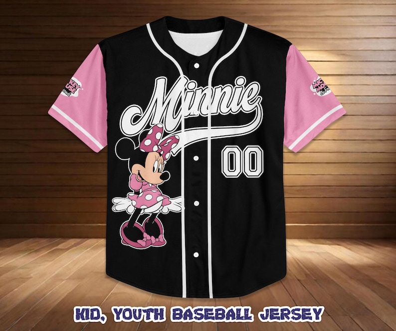 May include: Black baseball jersey with pink sleeves and white trim. Features a Minnie Mouse graphic and the name "Minnie" in white script. The number "00" is displayed on the front. The text "KID, YOUTH BASEBALL JERSEY" is at the bottom.