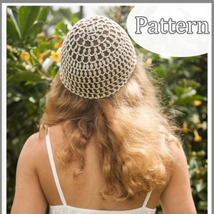 May include: A close-up of a crocheted hat with a circular pattern. The hat is made of white yarn and has a delicate, lacy design. The hat is shown on a model with long, blonde hair.