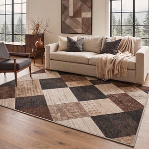 May include: A rectangular area rug featuring a geometric patchwork design with alternating squares in shades of dark brown, light beige, and tan. The pattern includes varied textures and subtle cross-stitch motifs across the surface.