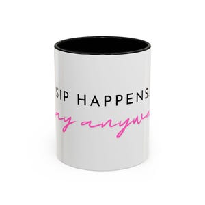 May include: White ceramic coffee mug with a black interior and the words "SIP HAPPENS" in black, with "anyway" in pink cursive. The mug is a standard size and shape.