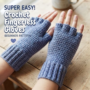May include: A pair of blue crochet fingerless gloves with a ribbed cuff and a textured stitch pattern. The text on the image reads: SUPER EASY! Crochet Fingerless Gloves BEGINNER PATTERN with a small blue heart icon below the text.