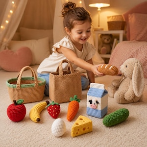 May include: A collection of crocheted toy food items including a red apple, yellow banana, red strawberry, orange carrot, white egg, yellow cheese wedge, blue and white milk carton, green cucumber, and brown bread loaf, alongside two woven baskets.