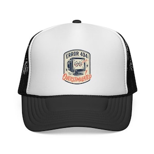 May include: A white and black trucker hat featuring a graphic print of a computer monitor with tired eyes, the text ERROR 404: OVERSTIMULATED, and small lightning bolt icons. The cap has a white front panel, a black brim, and black mesh back panels.