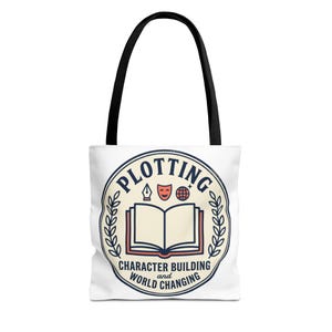 May include: A white tote bag with black handles featuring a circular graphic. The design includes an open book, a fountain pen nib, a theatre mask, and a globe, with the text PLOTTING, CHARACTER BUILDING and WORLD CHANGING in dark blue.
