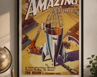 May include: A framed vintage science fiction magazine cover titled Amazing Stories, featuring a large silver rocket ship under construction, an orange crane, and a train, with the text A Smashing Novel of Super Science and The Brain by Alexander Blade.