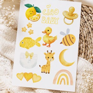 May include: A white sticker sheet featuring yellow-themed watercolour illustrations including a lemon, a dummy, a duck, a bee, a fish, a giraffe, a crescent moon, a rainbow, stars, hearts, a nappy, and the text CIAO BABY in yellow bubble letters.