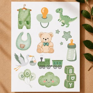 May include: A collection of watercolour-style baby-themed illustrations featuring a green romper, pacifier, dinosaur, bib, teddy bear with a bow, stars, baby bottle, stork, train, balloons with the text BOY, a cloud, and blocks spelling BOY.