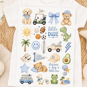 May include: A sheet of iron-on transfers featuring various illustrations including a golden retriever, golf cart, teddy bears, dinosaur, truck, surfboard, palm trees, sports balls, and text reading little dude, little explorer, and dream big little one.