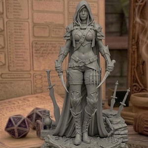 May include: A gray figurine of a hooded female warrior, holding two curved daggers. She wears armor and a cape, with swords and dice in the background. The figurine is on a detailed base.
