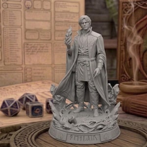May include: A gray resin tabletop miniature figure of a standing character wearing a long coat and tunic, holding a flame in one hand. The figure stands on a circular base with engraved runes, surrounded by swirling sculpted elements at the feet.