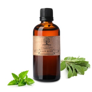 May include: A brown glass bottle with a black cap filled with amber liquid. The label is brown with a tree and the text "Nature's Note Organics 100% Pure Aromatherapy Essential Oil Sage Mint naturesnoteorganics.com". There are sprigs of sage and mint leaves on a white background.