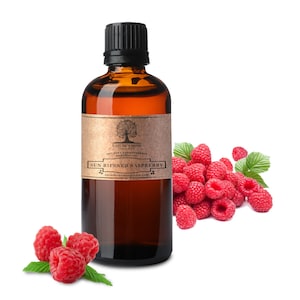 May include: A brown glass bottle with a black cap, labeled "Sun Ripened Raspberry" essential oil. Fresh red raspberries and green leaves are arranged beside the bottle. The label includes the text "Nature's Note" and "100% Pure Aromatherapy Essential Oil."