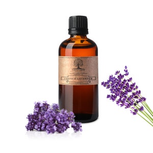 May include: A brown glass bottle of French Lavender essential oil with a black cap and a brown paper label. The label has a tree logo and the text "Nature's Note Organics 100% Pure Aromatherapy Essential Oil French Lavender naturesnoteorganics.com". A sprig of lavender flowers is next to the bottle.