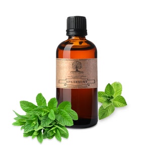 May include: A brown glass bottle with a brown paper label that says "Nature's Note 100% Pure Aromatherapy Essential Oil Spearmint naturesessentialsorganics.com". The bottle is surrounded by sprigs of fresh green mint.