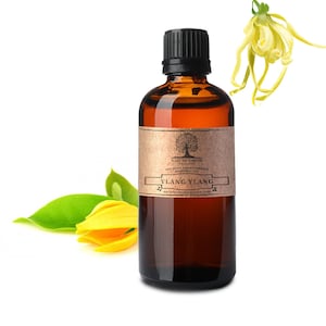 May include: A brown glass bottle with a black cap filled with Ylang Ylang essential oil. The bottle has a brown paper label with the text "Nature's Note Organic 100% Pure Aromatherapy Essential Oil Ylang Ylang naturesnoteorganics.com".