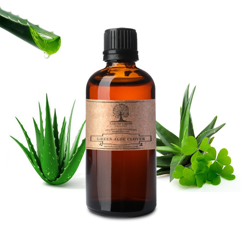 May include: A brown glass bottle with a black cap, labelled "NATURE'S NOTE" and "GREEN ALOE CLOVER". The bottle is surrounded by green aloe vera plants and clover leaves.