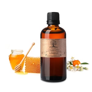May include: A brown glass bottle with a black cap filled with amber liquid. The bottle has a brown paper label with the text "Nature's Note" and "Neroli" on it. The bottle is sitting on a white surface with a honeycomb, a jar of honey, and a honey dipper.