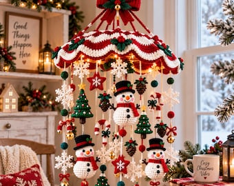 May include: A hanging Christmas mobile featuring crocheted figures including snowmen with black hats and red scarves, green pine trees, red stars, white snowflakes, pinecones, and candy canes, all suspended from a red and white scalloped canopy.