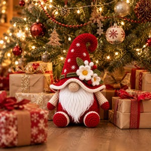 May include: A crocheted gnome figurine featuring a tall red pointed hat with white snowflake embroidery, a long white beard, a beige nose, and a decorative cluster of white flowers with green leaves attached to the side of the hat brim.