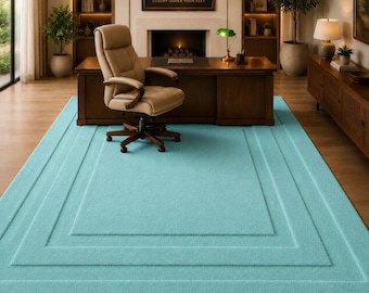 May include: A large, rectangular, solid light turquoise area rug featuring a textured surface with a series of concentric, recessed rectangular borders that create a subtle, layered visual effect across the entire floor covering.