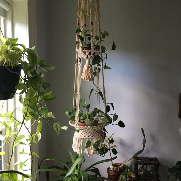 large two tier braided white macrame planter. mid century boho hanging planter. wood bead braided hanging planter. boho beaded planter plant
