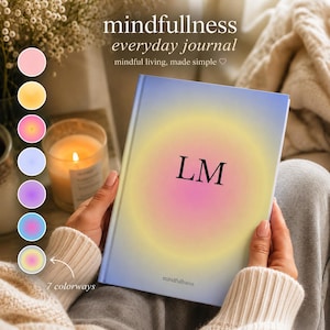 May include: A journal with a gradient design in shades of yellow, pink, and blue, held by a person. The journal cover features the initials "LM" and the word "mindfullness". The text "mindfullness everyday journal" is at the top. Seven color options are shown.