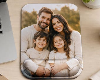 May include: A rectangular mouse pad featuring a printed photograph of a family of four, including two adults and two children, all smiling. The mouse pad has a built-in wrist rest at the bottom and rounded corners, displaying a warm outdoor scene.