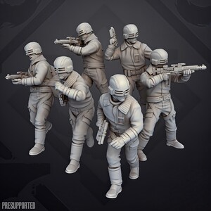 Può includere: Un set di sei miniature di soldati grigio chiaro in equipaggiamento tattico, ognuno con un casco con visiera e armato di fucile o pistola. Le figure sono in varie pose d'azione. Il testo PRESUPPORTED è visibile nella parte inferiore.
