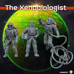 May include: Three grey miniature figures in space suits, with one wearing a helmet, one holding a helmet, and one floating with a tether. The text The Xenobiologist appears at the top against a green planet background with stars.