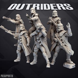 May include: A set of five unpainted grey miniature soldier figurines, each wearing tactical armour with long coats and helmets, holding rifles. The word OUTRIDERS is printed in white at the top, and the word PRESUPPORTED is at the bottom left.