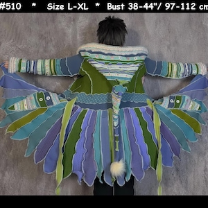 May include: A multi-colored knitted cardigan with a long, flowing tail. The cardigan is made of a variety of different colored yarns, including green, blue, and purple. The cardigan has a hood and a long, flowing tail that is made of a variety of different colored yarns. The cardigan is size L-XL and has a bust measurement of 38-44" / 97-112 cm.