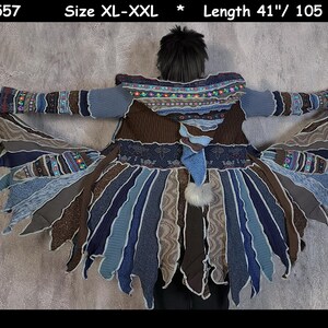 May include: A long, brown, blue, and gray knitted cardigan with a hood and fringe. The cardigan is made of recycled materials and has a unique, layered design. The cardigan is size XL-XXL and is 41 inches long.
