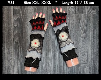May include: Fingerless gloves in black, gray, and red with a layered, ruffled design and a white flower appliqué with a red center. The gloves are labeled #81, size XXL-XXXL, and measure 11 inches in length.