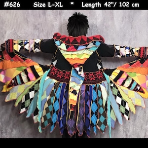 May include: A long coat, #626, size L-XL, length 102 cm, featuring a black base with a multi-coloured patchwork design of argyle patterns, solid fabric strips, and a hood. The garment has a flared, layered hem with various bright colours.