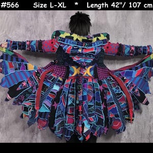 May include: A multi-colored patchwork hooded coat featuring a variety of fabric patterns including stripes, stars, and geometric shapes in shades of blue, pink, black, and yellow. The garment is labeled #566, size L-XL, and has a length of 42 inches.